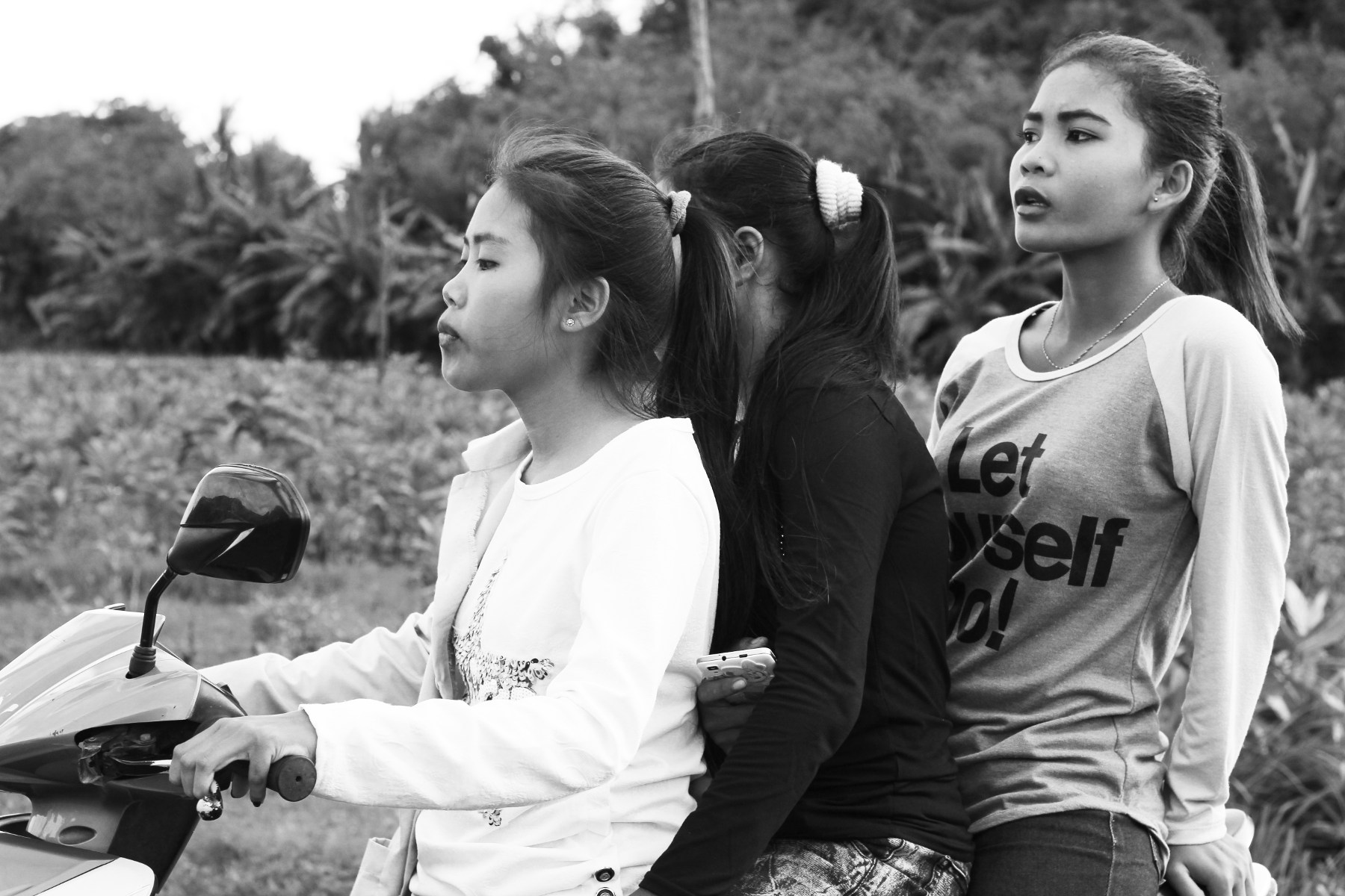 Three girls on the same scooter