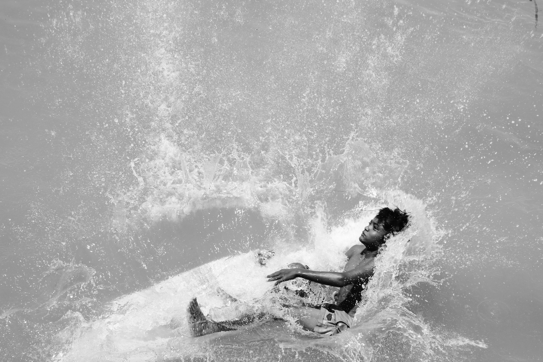 Kid with his surf board in the water